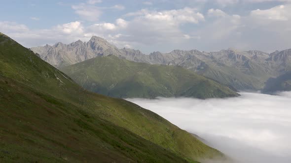 Rocky Mountain Summits and High Altitude Meadow Over the Clouds