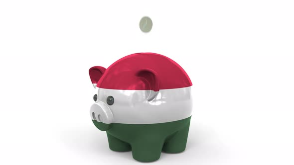 Coins Fall Into Piggy Bank Painted with Flag of Hungary alt