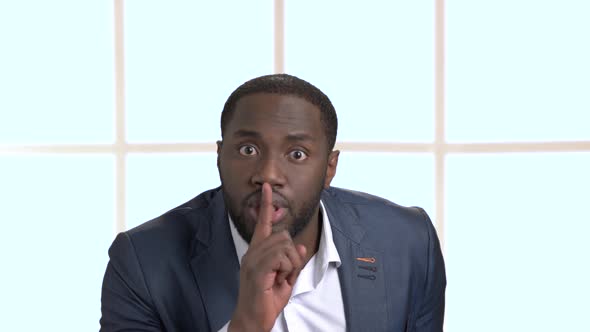 Confident Black Businessman Showing Silence Gesture.