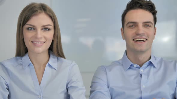 Smiling Young Business People Looking at Camera in Office Colleagues