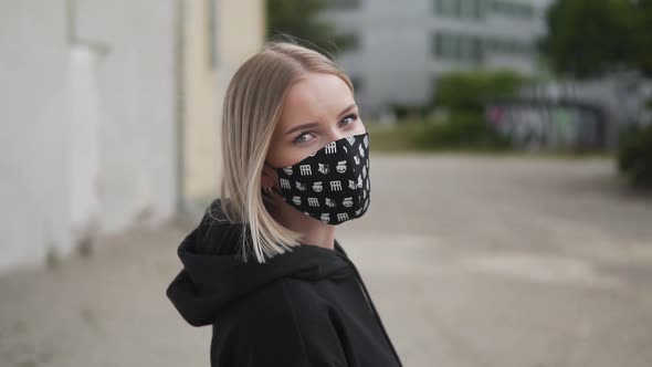 Young Modern Girl With Protective Face Mask in Urban Exterior, Slow Motion. New Normal and Covid-19