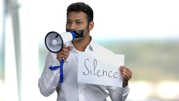 Silenced Businessman on Blurred Background.