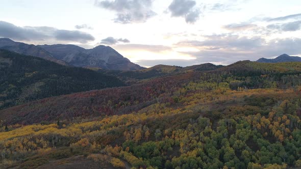 Fall color spanning over mountain landscape at sunset