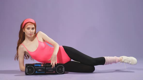 Fit Ginger Female Model Poses for Commercial Photoshoot for Aerobics Sportswear