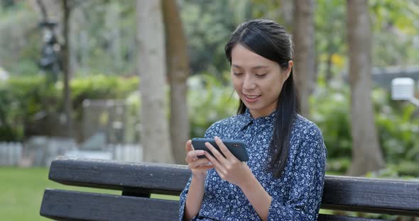 Woman use of mobile phone in the park