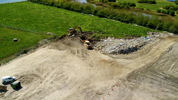 Excavator Digging Up Soil And Load On Truck, Drone Stock Footage