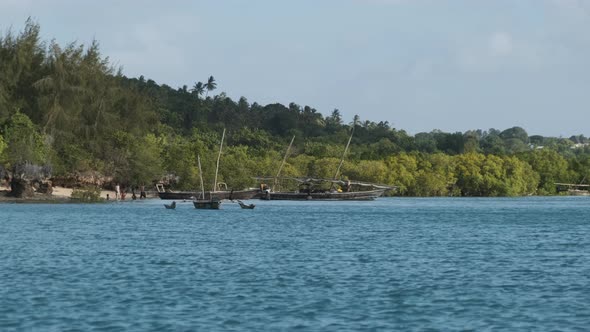 View From Ocean to Wooden Fishing Boats Anchored Near Coast of African Village