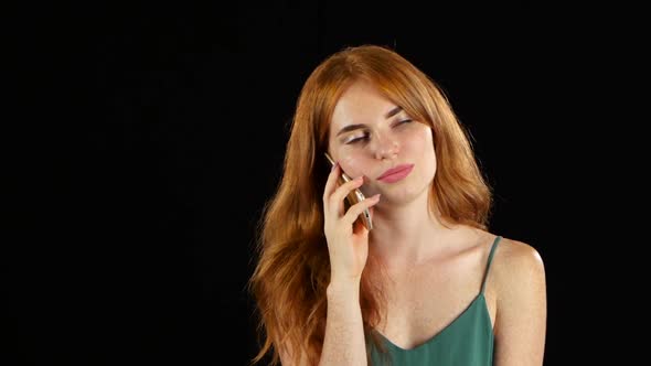 Girl Talking on the Phone. Black Background