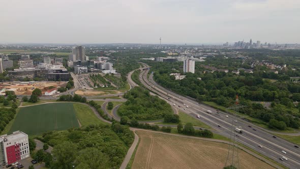 Aerial time lapse of busy traffic on the german autobahn a66 with the cityscape of Frankfurt am Main