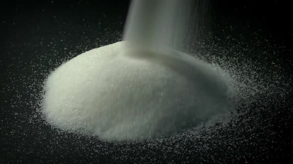Sugar Pours Into Pile Food Product