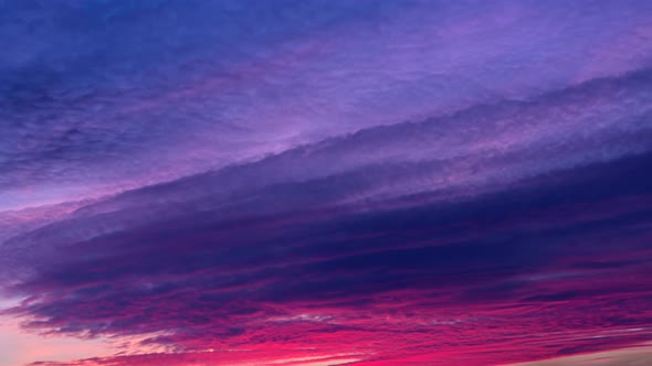 Pink sunset clouds timelapse. Golden hour to blue hour. Colorful tropical beautiful sunset.