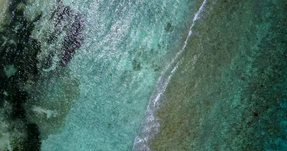 Tropical aerial abstract shot of a white sand paradise beach and aqua blue water background in colou