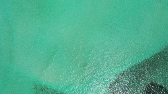 Aerial top down seascape of perfect tourist beach lifestyle by clear water and white sandy backgroun