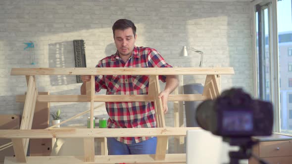 Portrait of a Male DIY Blogger in a Workshop Recording a Video