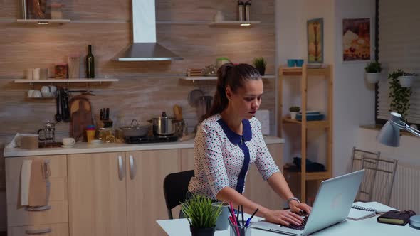 Businesswoman Typing on Laptop While Working Remotely