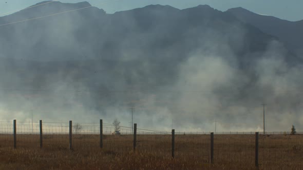 Fire distant with car driving trough