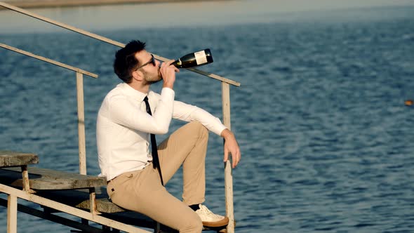 Man Drink Champagne And Relaxing Near River. Man Finished Project Work Admire Chill View. Drink Wine