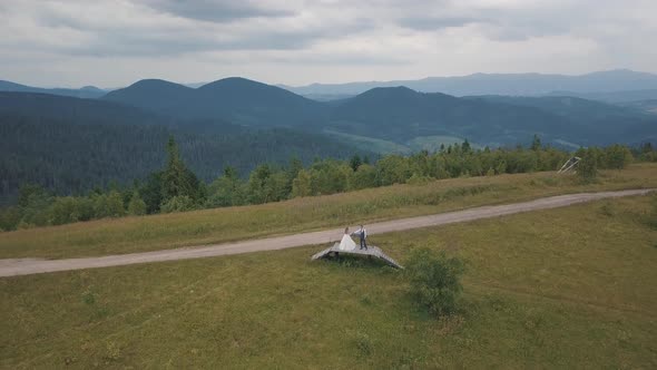 Groom with Bride Together on a Mountain Hills. Aerial Drone Shot