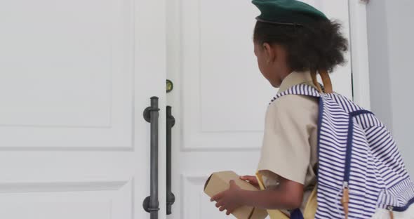 Animation of african american girl in scout costume delivering package to biracial woman