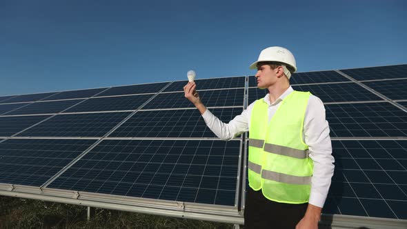 The Engineer is Standing Next to the Solar Panels