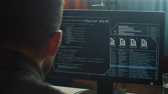 Closeup of Computer Hacker Typing a Code to Break the Server