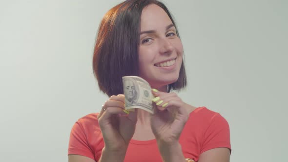 Close up of a woman showing a dollar bill