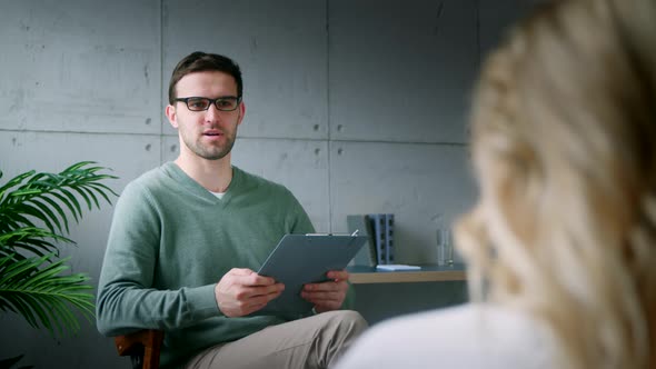 Professional psychiatrist interviewing a young girl