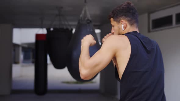 Martial Art Fighter Does Shadow Boxing Kickboxer Training Strikes in Gym