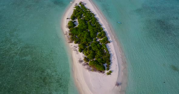 Wide birds eye abstract shot of a summer white paradise sand beach and blue water background in vibr