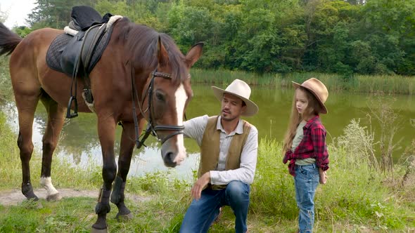 Cowboy and His Daughter with Their Horse