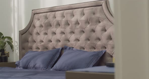 Closeup of Purple Pillows with Floral Patterns and Purple Cover on the Bed