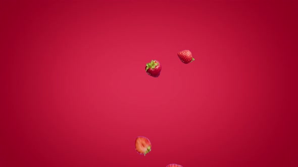 Halves of Strawberries Falling on a Red Background