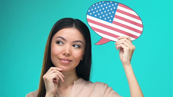 Dreaming Pretty Female Holding American Speech Bubble, Fluent Foreign Language