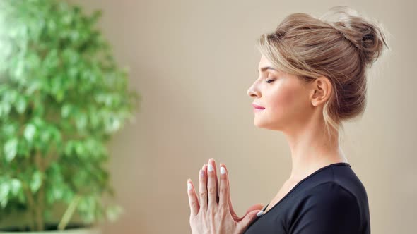 Smiling Young European Woman Enjoying Meditation Showing Hand Namaste Gesture Medium Closeup