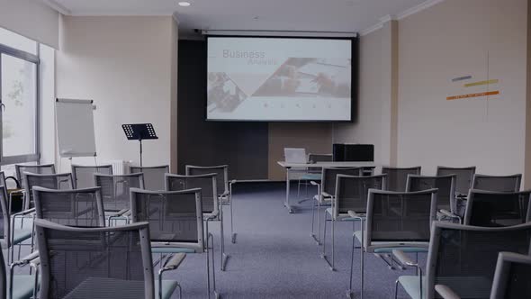 Empty business meeting room with a power point presentation ready to be explained to business partne