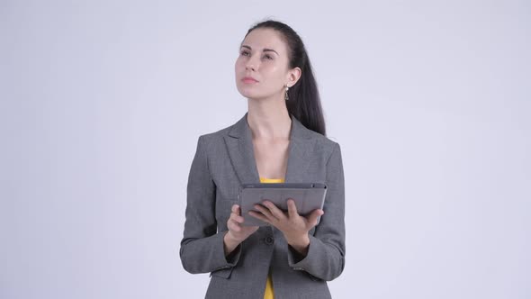 Happy Young Beautiful Businesswoman Thinking While Using Digital Tablet