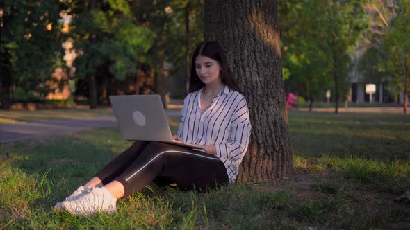 Smiling Woman Using Laptop in Park Freelancer Distance Working Relax Outdoor