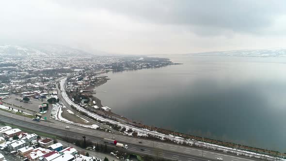 Lake, city and road in winter.