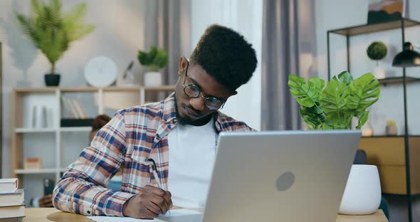 Man Working on Computer while Woman Playing with child