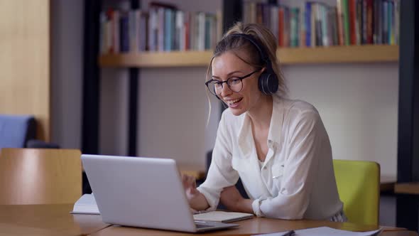 Blonde Woman Study at Distant Learning at Library