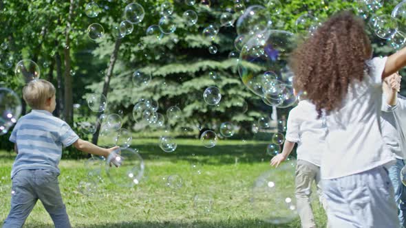 Playful Kids Catching Soap Bubbles alt