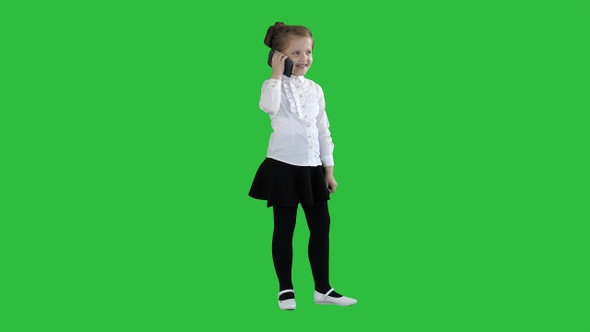 Happy girl with mobile phone Isolated on a Green Screen