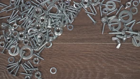 Type of Bolts Nuts Screws on the Table Closeup Hand