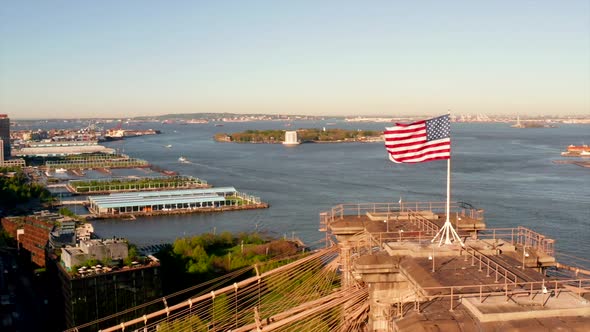 American national flag on top of the Brooklyn bridge