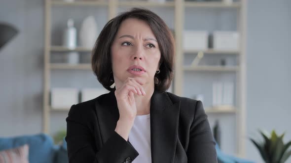 Portrait of Beautiful Thinking Woman Gesturing Brainstorming