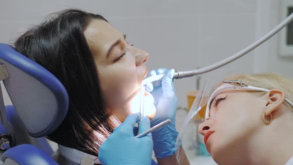 Dentist Doing a Dental Treatment on a Female Patient