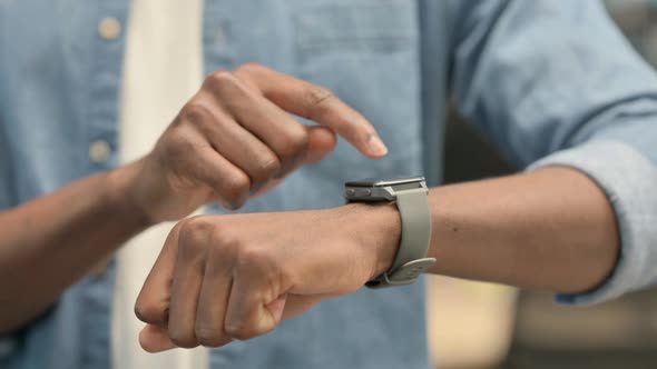 Hands of African Man Using Smartwatch