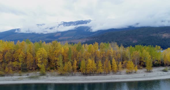 Autumn forest and mountain ranges along the lake 4k