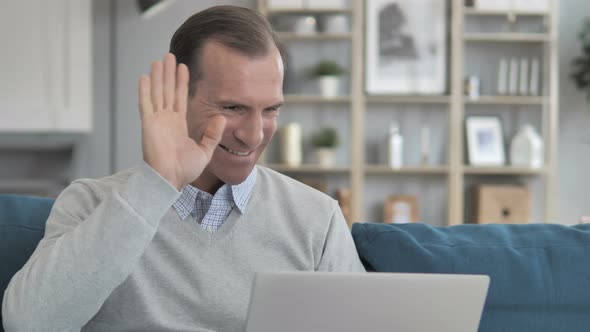 Online Video Chat by Middle Aged Man Sitting at Creative Workplace
