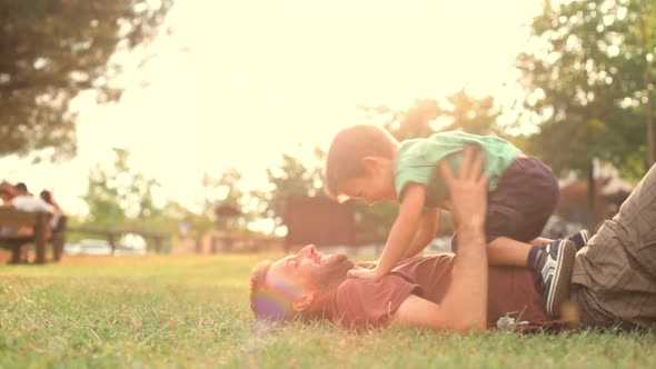 Happy Child Play with Dad at Sunset Park Summer Outdoor